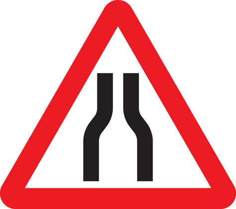 Road narrows on both sides
